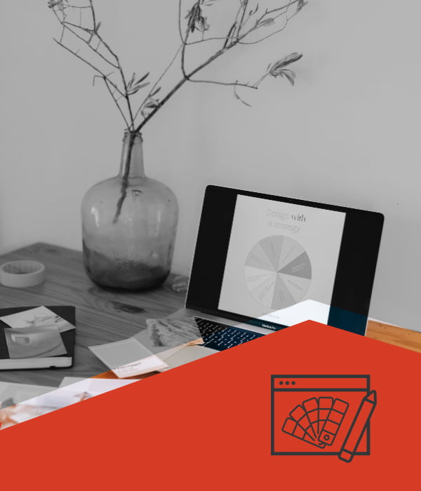 A desk showing the design and branding services that Obsidian Atlas offers.